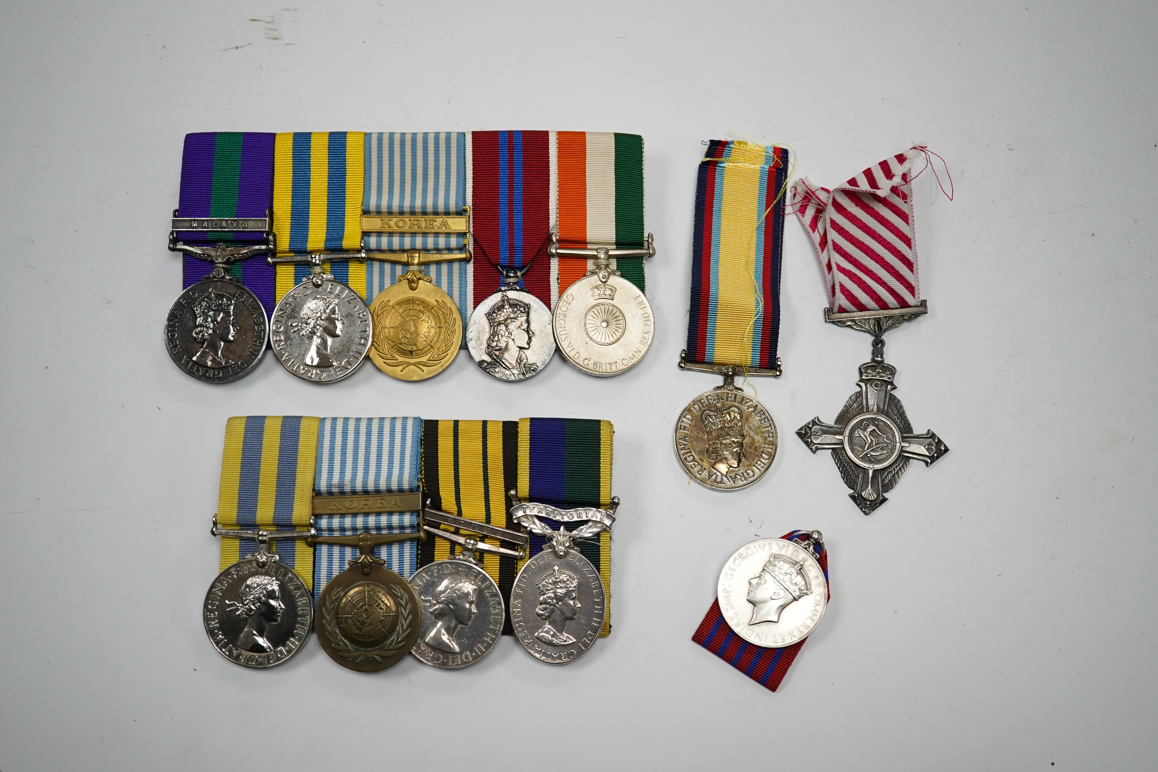 Twelve ERII and George VI medals, some medals arranged into two medals groups (containing unnamed medals and medals awarded to different recipients within the same group), including